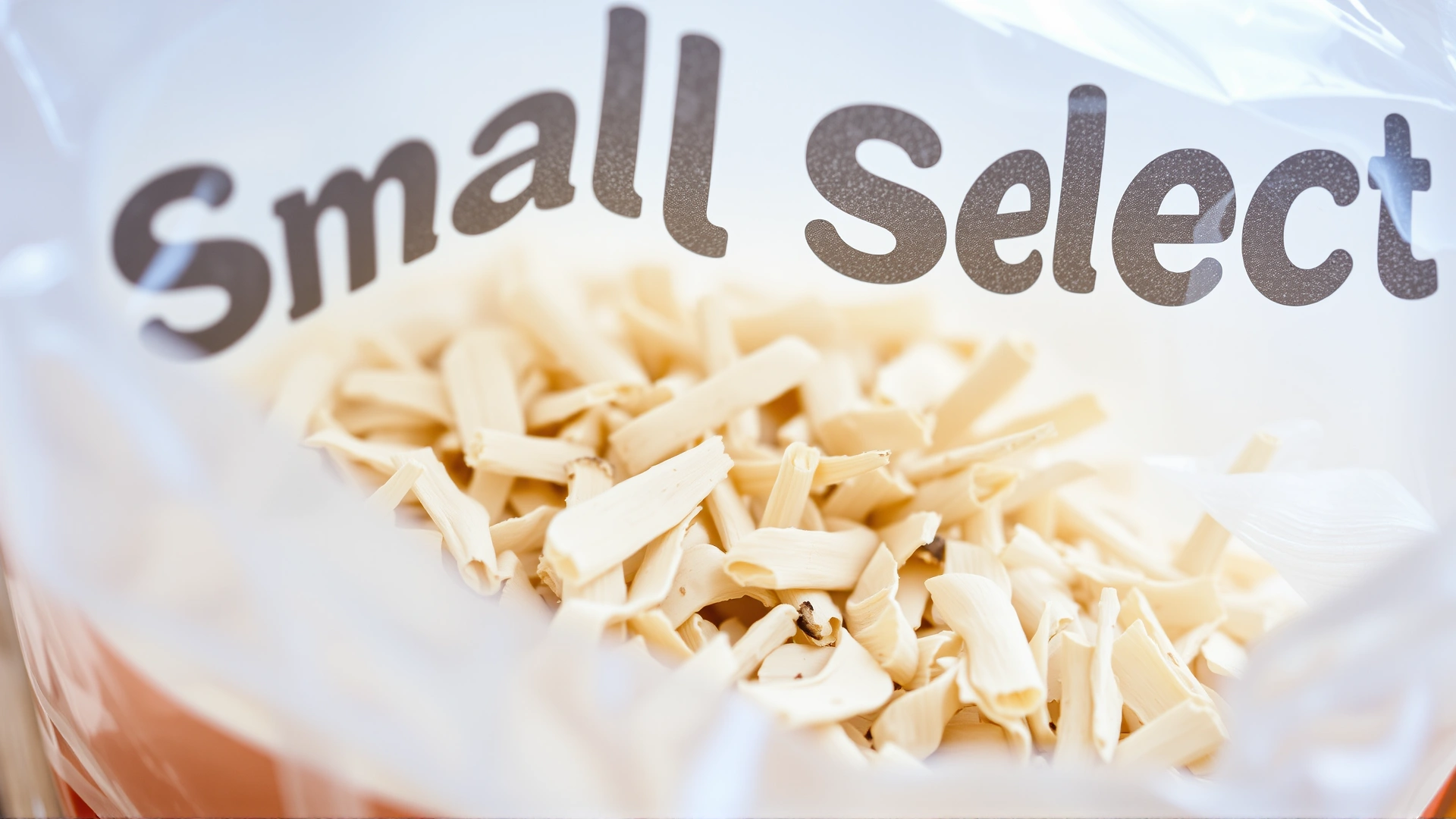 Close-up shot of a bag of Small Pet Select Aspen Shavings with the natural wood texture clearly visible