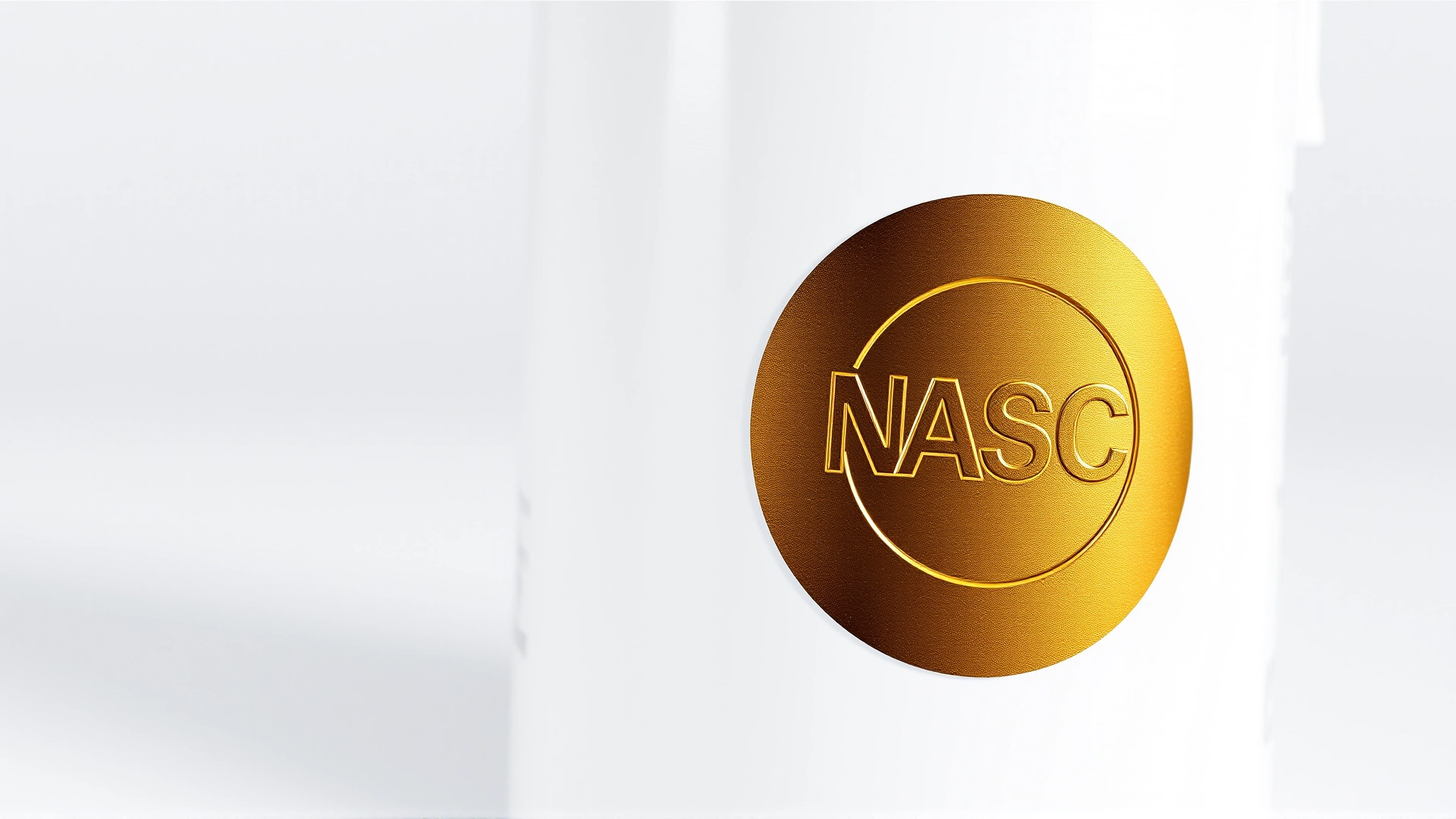 Macro shot of a pet supplement container displaying a shiny gold NASC Quality Seal sticker; white background, sharp focus