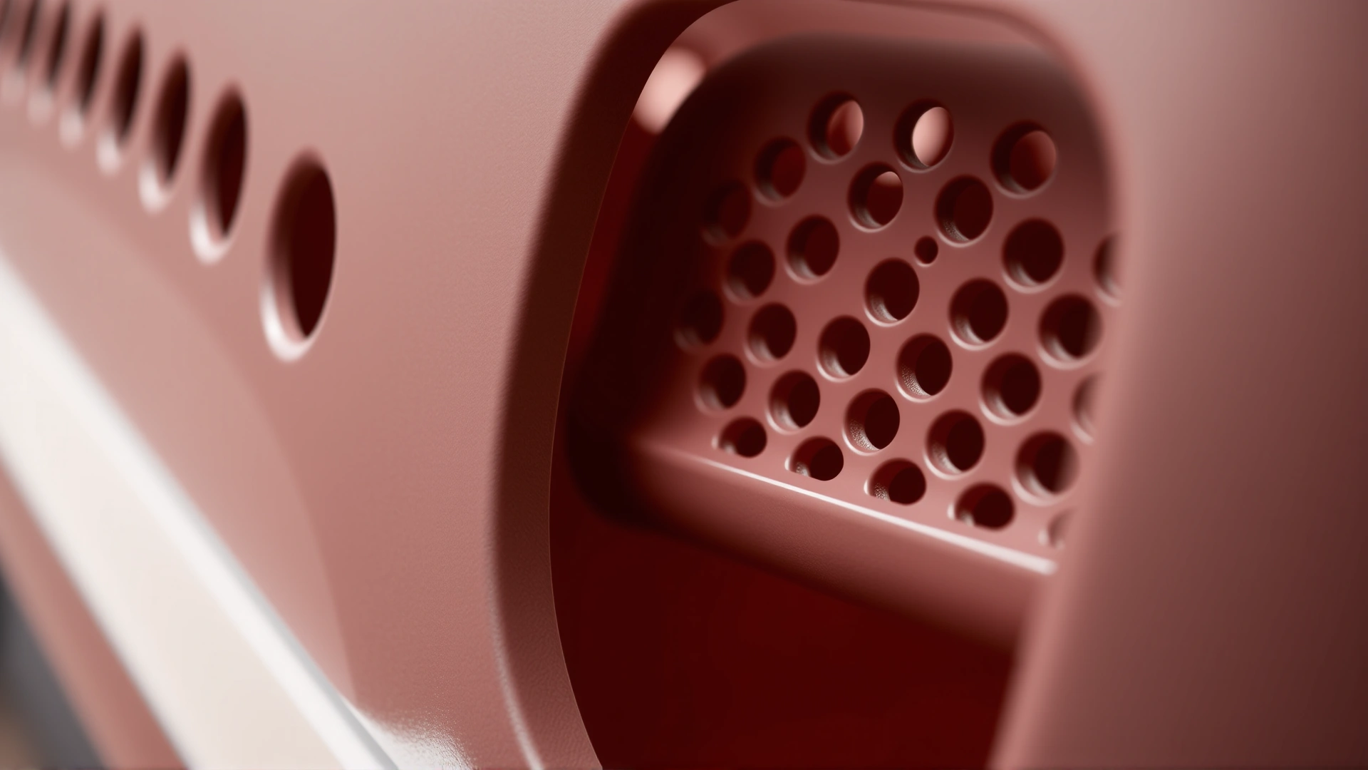 Macro shot focusing on the ventilation holes of a modern pet carrier, demonstrating airflow and design quality.